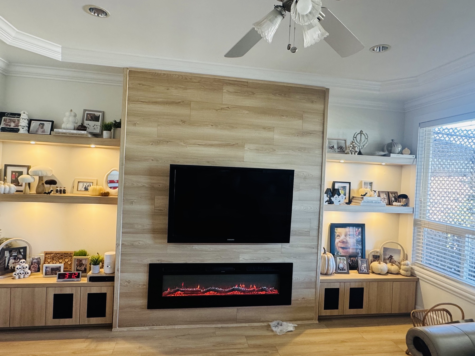 Timber feature wall with a linear fireplace and shelving