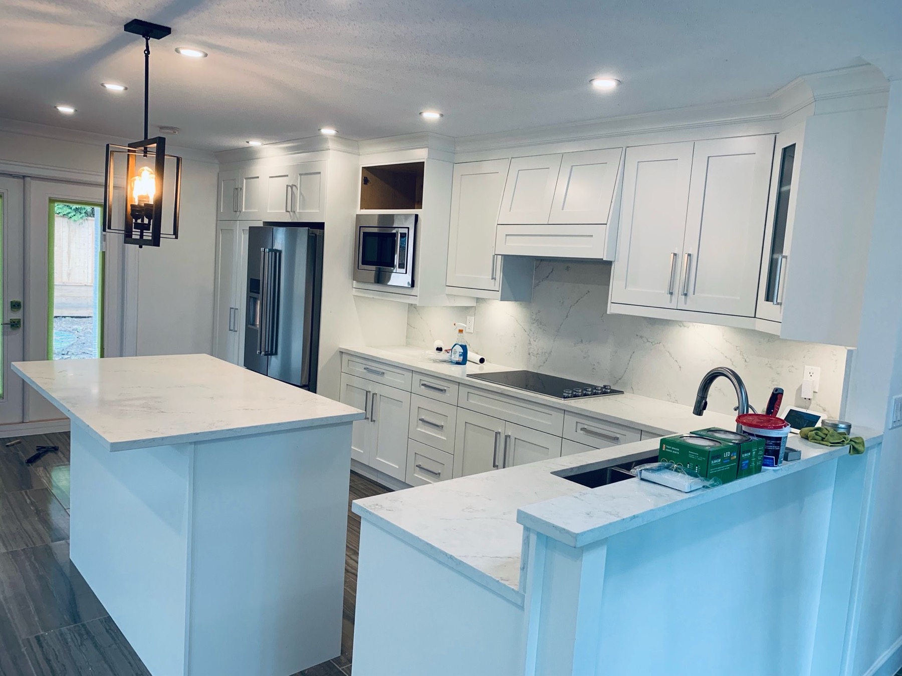 Renovated kitchen with island and quartz counters