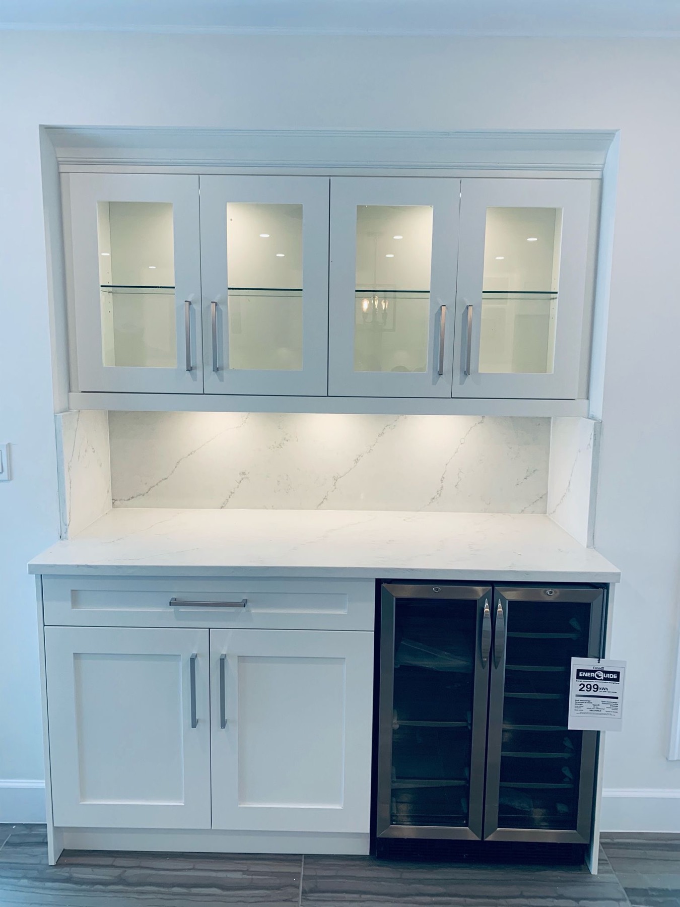Glass fronted cabinetry with integrated wine fridge
