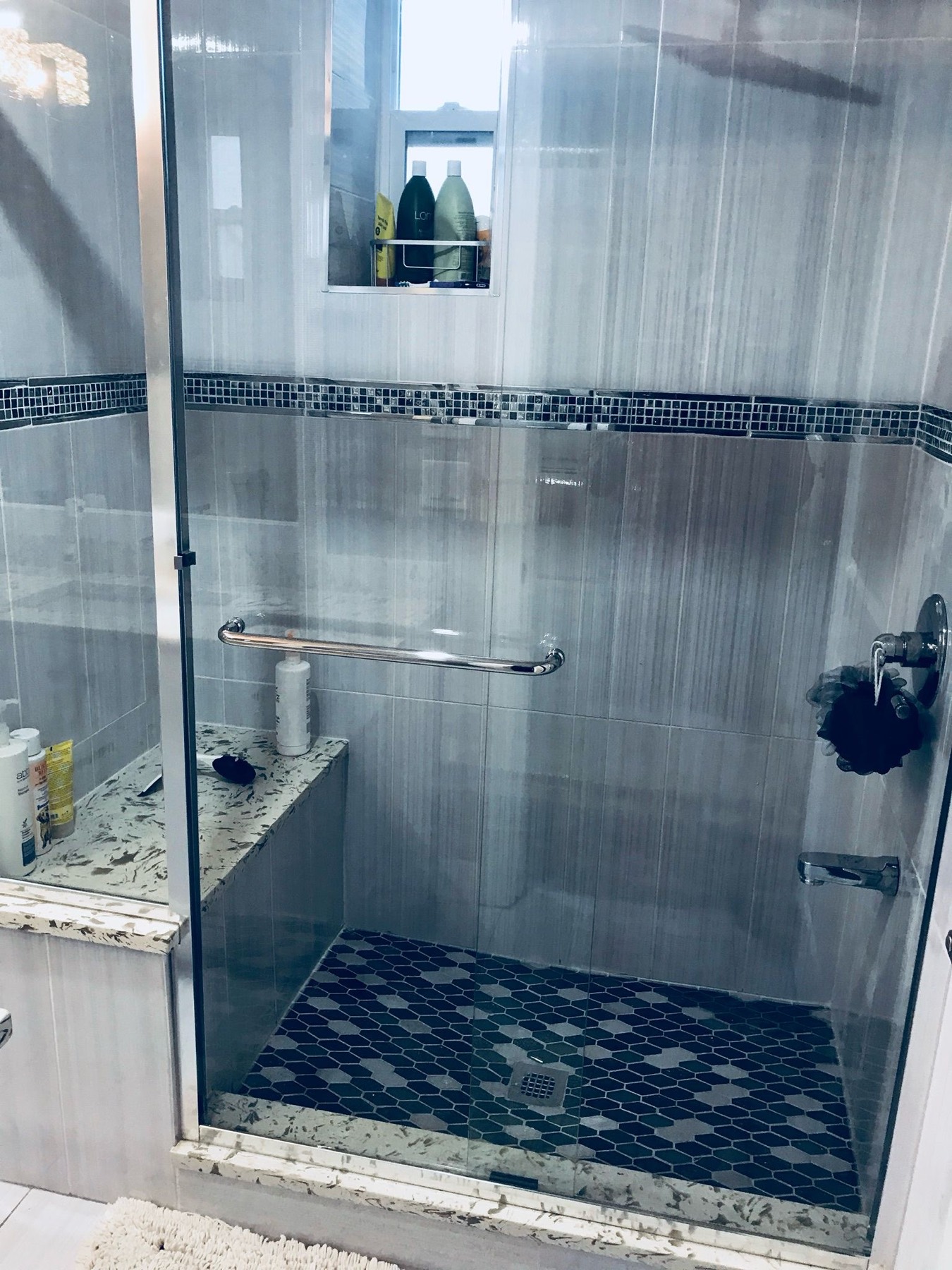 Ceramic tile shower with patterned mosaic floor