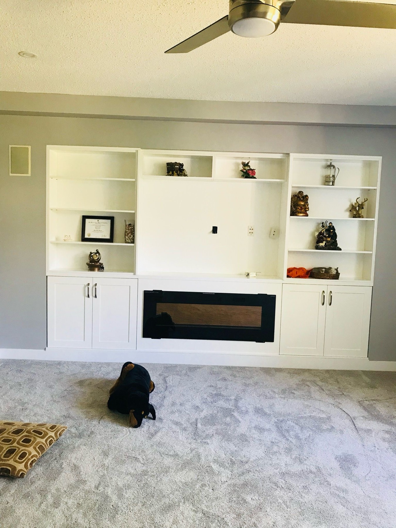 Built in shelving either side of a linear fireplace