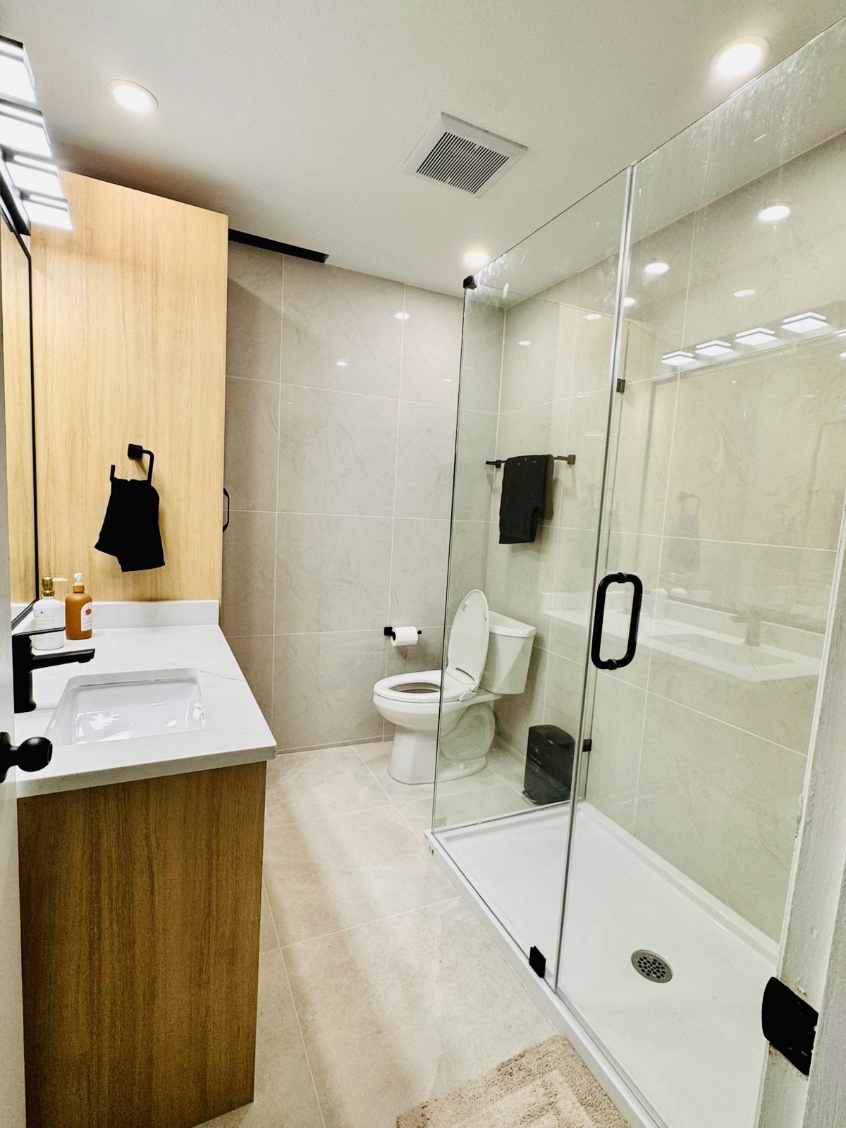 Compact washroom with glass shower and floating vanity