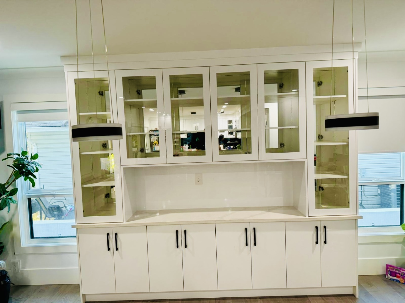 Full wall built in unit with glass upper doors and drawer bases